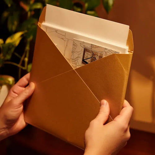 Unboxing a cold case kit for mystery board games - envelopes, photos and notes slide out to start the investigation.